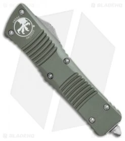 Microtech Combat Troodon D/E OTF Automatic Knife OD Green (3.8" Apocalyptic) -Blade HQ Shop Microtech Combat Troodon DE OTF Automatic Knife OD Green 3.8in Apocalyptic 142 10APOD BHQ 115739 LS Spine
