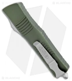 Microtech Combat Troodon T/E Automatic OTF Knife OD Green (3.8" SW Serr) -Blade HQ Shop Microtech Combat Troodon Tanto OD Green SW Serr 144 11OD BHQ 98204 jr side