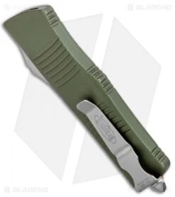 Microtech OD Green Troodon D/E OTF Automatic Knife (3" Satin Serr) 138-5OD 8 Microtech OD Green Troodon D/E OTF Automatic Knife (3" Satin Serr) 138-5OD -Blade HQ Shop Microtech OD Green Troodon DE OTF Auto Satin Serr 138 5OD BHQ 13106 jr side
