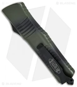 Microtech Combat Troodon Bowie OTF Automatic Knife (3.8" Green Camo Serr) -Blade HQ Shop Microtech OTF Combat Troodon Bowie Green Camo Serr 146 2GC BHQ 68507 jr side