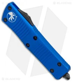 Microtech Blue Troodon D/E OTF Automatic Knife (3" Black Full Serr) 138-3BL -Blade HQ Shop Microtech Troodon DE OTF Blue Black Full Serr 138 3BL BHQ 12601 jr spine