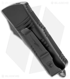 Microtech Troodon Mini D/E CA Legal OTF Auto Black (1.9" Black DLC Serr) -Blade HQ Shop Microtech Troodon Mini DE CA Legal OTF Auto Shadow Black DLC Serr BHQ 146607 jr side