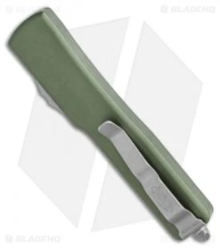 Microtech UTX-70 D/A OTF Automatic Knife OD Green (Apocalyptic Full Serr) -Blade HQ Shop Microtech UTX 70 DA OTF DE Automatic Knife OD Green Apocalyptic Full Serr 147 12APOD BHQ 115741 LS Side