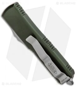 Microtech UTX-85 D/E OTF Automatic Knife OD Green (3.125" Satin Full Serr) -Blade HQ Shop Microtech UTX 85 DE OTF Auto OD Green Satin Serr Full 232 6OD BHQ 90985 jr side
