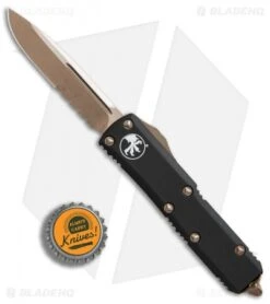 Microtech UTX-85 S/E OTF Automatic Knife Black (3.1" Bronze Serr) -Blade HQ Shop Microtech UTX 85 SE black bronze serr BHQ 75684 er bottlecap